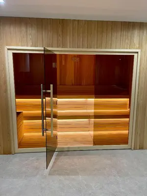 a closet with wooden cabinets and a glass door at Apartman Lawa Kopaonik in Kopaonik