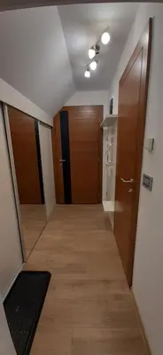 a hallway with wooden doors and a hallway sidx sidx sidx at Vila Breg Kopaonik Centar in Kopaonik