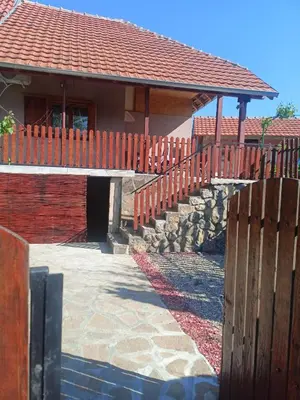 a house with a wooden fence and a walkway at Apartman vikend kuca Hs in Pirot