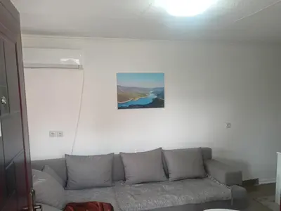 a couch in a living room with a painting on the wall at Apartman vikend kuca Hs in Pirot