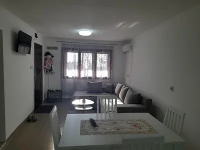 a living room with a couch and a table at Apartman vikend kuca Hs in Pirot