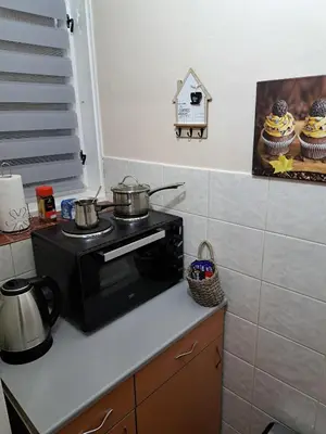 a kitchen with a stove with pots and pans on it at Apartman Dream M Zaječar in Zaječar