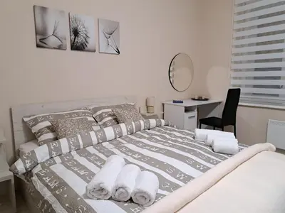 a bedroom with a bed with towels on it at Apartman Dream M Zaječar in Zaječar