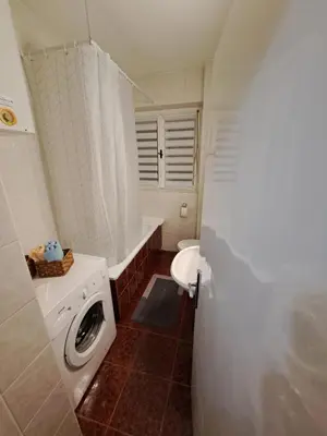a bathroom with a washing machine and a toilet at Apartman Dream M Zaječar in Zaječar
