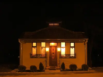a small house with lights on the door at night at Vila Lira in Vrnjačka Banja