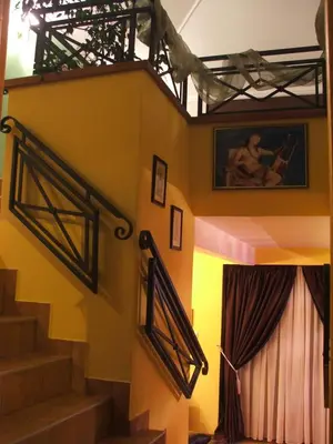 a room with stairs and a stage with a curtain at Vila Lira in Vrnjačka Banja