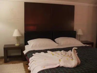 a bed with a bunch of towels laying on it at Vila Lira in Vrnjačka Banja