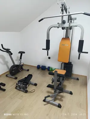 a gym with several exercise bikes on the floor at Garfield Family Apartman 2 in Soko Banja