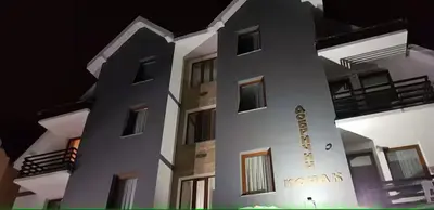 a tall white building with a sign on it at Dobricin Konak Kopaonik in Kopaonik