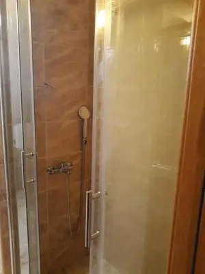 a shower with a glass door in a bathroom at Dobricin Konak Kopaonik in Kopaonik
