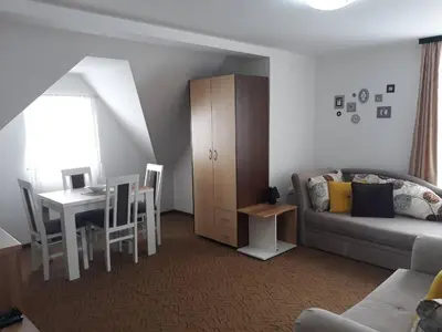 a living room with a couch and a table at Dobricin Konak Kopaonik in Kopaonik