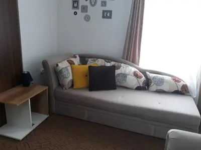 a couch with pillows on it in a living room at Dobricin Konak Kopaonik in Kopaonik