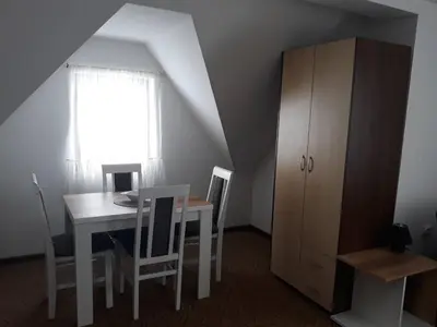 a dining room with a table and chairs and a window at Dobricin Konak Kopaonik in Kopaonik
