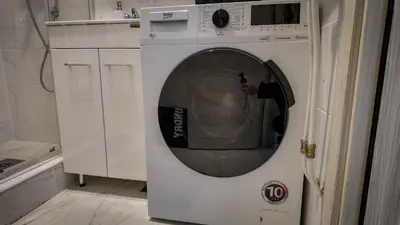 a person taking a picture of a washing machine at Apartman Jovanović in Pirot