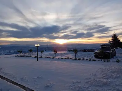 a car parked in a parking lot in the snow at Residence Hill Lux in Kopaonik