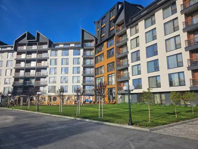 an empty street in front of an apartment building at Residence Hill Lux in Kopaonik