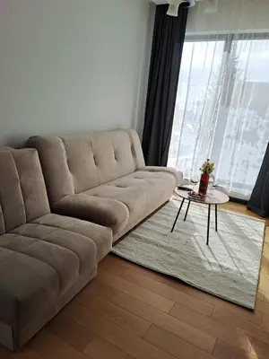 a brown couch in a living room with a table at Winter House in Kopaonik