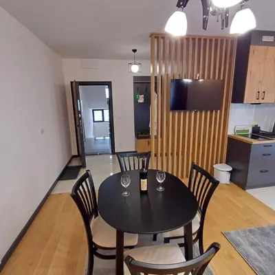a kitchen and dining room with a table and chairs at Winter House in Kopaonik