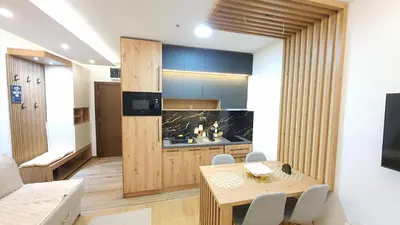 a living room with a table and a television at Apartmani Kasandra Wellness Spa A203 President Kop Kopaonik in Kopaonik
