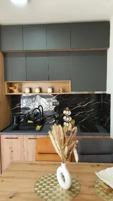 a kitchen with a wooden table with a vase on it at Apartmani Kasandra Wellness Spa A203 President Kop Kopaonik in Kopaonik