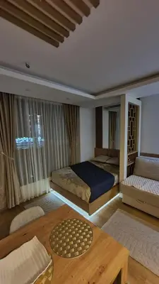 a bedroom with two beds and a coffee table at Apartmani Kasandra Wellness Spa A203 President Kop Kopaonik in Kopaonik