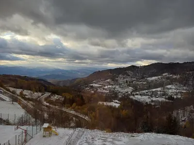 a view of a ski slope with snow and trees at View N52A in Kopaonik