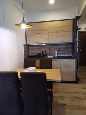 a kitchen with a wooden table and a sink at View N52A in Kopaonik