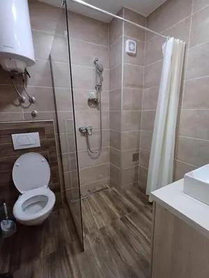 a bathroom with a shower with a toilet and a sink at View N52A in Kopaonik