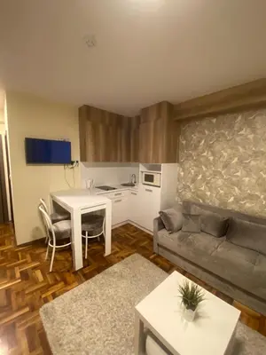 a living room with a table and a couch at Apartman Marta - Kraljevi Čardaci in Kopaonik
