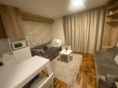 a small living room with a couch and a table at Apartman Marta - Kraljevi Čardaci in Kopaonik