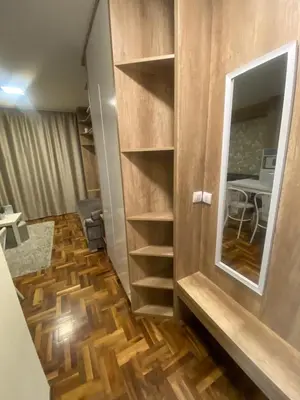 a room with a wooden floor and a mirror at Apartman Marta - Kraljevi Čardaci in Kopaonik