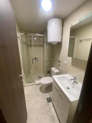a bathroom with a shower and a toilet and a sink at Apartman Marta - Kraljevi Čardaci in Kopaonik