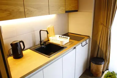 a small kitchen with a sink and a counter at studio apartman Najdanović CENTAR in Vrnjačka Banja