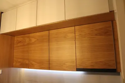 a large wooden cabinet hanging on a wall at studio apartman Najdanović CENTAR in Vrnjačka Banja