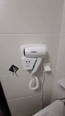 a hairdryer on a wall in a bathroom at studio apartman Najdanović CENTAR in Vrnjačka Banja