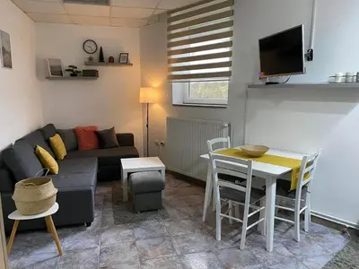 a living room with a couch and a table at Vila Plan Apartman 101 in Kopaonik