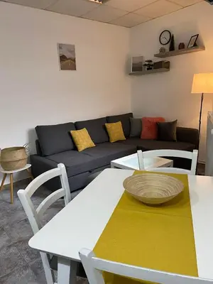 a living room with a couch and a table at Vila Plan Apartman 101 in Kopaonik