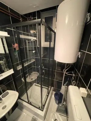 a bathroom with a shower and a toilet and a sink at Vila Plan Apartman 101 in Kopaonik