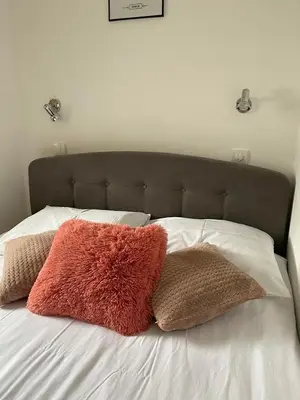 two pillows on top of a white bed at Vila Plan Apartman 101 in Kopaonik