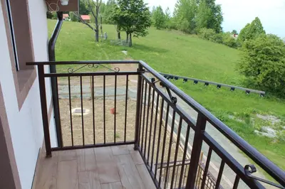 a balcony of a house with a view of a field at Panorama house Goč in Goč