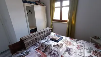 a bedroom with a bed with a floral bedspread at Panorama house Goč in Goč