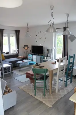 a living room with a wooden table and chairs at Panorama house Goč in Goč