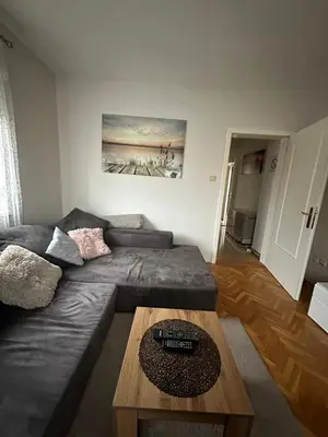 a living room with a couch and a coffee table at Apartman Tiki R Vrnjacka Banja in Vrnjačka Banja
