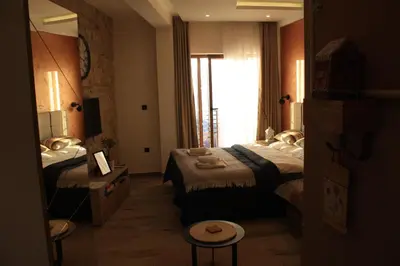 a hotel room with two beds and a mirror at Silvani Kop NLux67, Milmari Apartments & Spa in Kopaonik