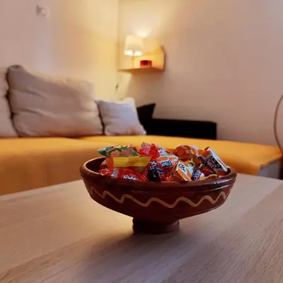 a bowl of candy on a table in a living room at Kuća Drinčić in Kopaonik
