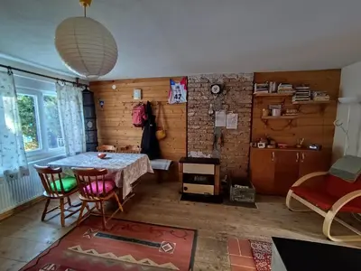 a dining room with a table and chairs in a room at Kuća Drinčić in Kopaonik