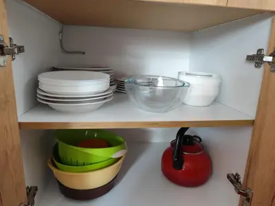 a shelf with plates and bowls and other dishes at Kuća Drinčić in Kopaonik