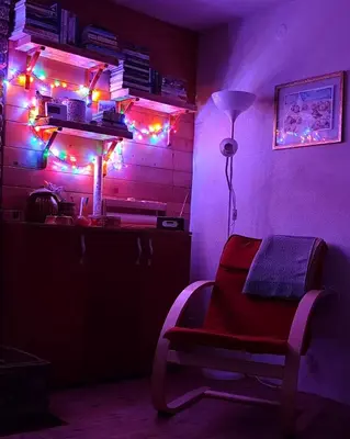 a room with a lamp and a chair with lights at Kuća Drinčić in Kopaonik