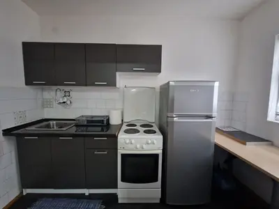 a kitchen with a stainless steel stove and refrigerator at Apartman VRANJANKA in Vranje