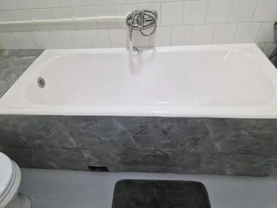 a white bath tub in a bathroom with a toilet at Apartman VRANJANKA in Vranje